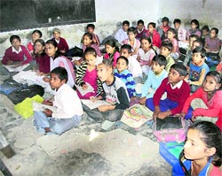 Students of Government Primary School, Basti Peer Daad, study while sitting on a broken floor
