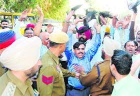 PCCTU teachers show black flags to Education Minister Sewa Singh Sekhwan during his arrival at an exhibition at St Francis School in Amritsar on Thursday