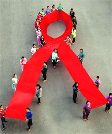 NSS volunteers of GCG-42 hold a red ribbon during an AIDS campaign ‘Junoon’ on the college campus in Chandigarh on Thursday
