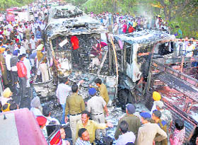 Policemen and firefighters at the site of the mishap on Barnala road in Bathinda
