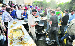 Party activists relish food at the venue for the function.