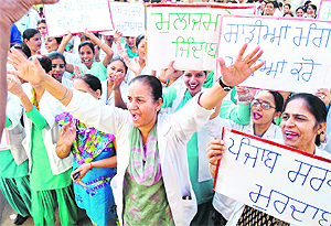 Members of the joint action committee, Government Rajindra Hospital, Government Medical College, Dental College and the Ayurvedic College holding a protest against the Punjab government in support of their demands in Patiala, on Thursday. 