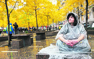 Protester Jorden Eck sits in New Yorks Zuccotti Park a day after it was cleared of protesters in an early morning police raid, on Thursday