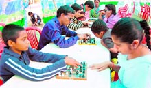 Visually impaired children participate in a chess competition at Guru Nanak Dev University in Amritsar on Friday