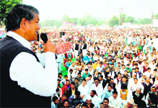 Union Minister of State for Agriculture, Food Processing and Parliamentary Affairs Harish Rawat addresses a rally in Haridwar on Friday. 
