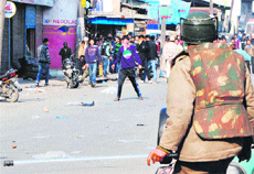 Protesting youth and security personnel clash in Srinagar city on Friday. 