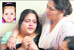 The inconsolable mother of 2-year-old Bramjap (inset) at her residence in the Central Town area of Jalandhar on Friday
