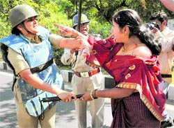 A woman Congress activist in a scuffle with the police during a protest against Opposition leader Sushma Swaraj and Madhya Pradesh Chief Minister Shivraj Singh Chouhan in Bhopal on Friday