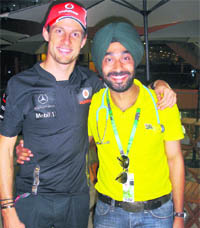 Sandhu shares a moment with Jenson Button at the inaugural Indian Grand Prix