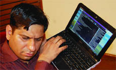 A visually impaired person operates his laptop by hearing its voice instructions in Amritsar. 
