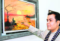 Artist Dr Sudeep Ranjan Sarkar at his painting exhibition in Amritsar. 