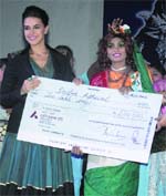 Former scavenger Indira Athwal (R) who won the New Princess 2011 award during a function to mark World Toilet Day with former Miss India Neha Dhupia in