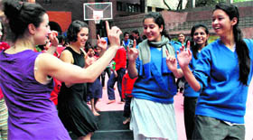 Students of Welham Girls' School dance with members of De Stilte, a group from the Netherlands, in Dehradun on Saturday.