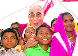 The Dalai Lama with slum children at the inauguration function of the Tong-len Charitable Trust at Sarah near Dharamsala on Saturday