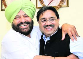 Friends again! Chairman of Jalandhar Improvement Trust Baljit Singh Neelamahal and Mayor Rakesh Rathour hug each other in Jalandhar on Saturday