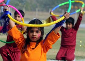 Schoolgirls participate in a function at Tau Devi Lal Stadium in Gurgaon