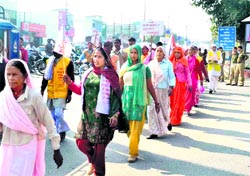 Women activists of an ashram take out an anti-liquor march in Haridwar on Sunday