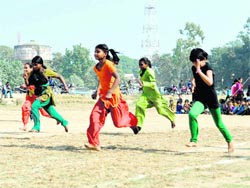 Children from slums participate in a racing competition at the Parade Ground in Dehradun on Sunday