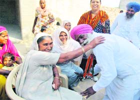 An elderly woman blesses Congress candidate Jarnail Singh during his campaign in Ratia on Sunday