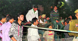 Kabaddi fans cross barricades erected by the Ludhiana police outside Guru Nanak Stadium in Ludhiana on Sunday.