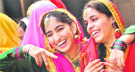 Girls share a light moment before their dance performance during the annual function of RS Model School in Ludhiana on Sunday.