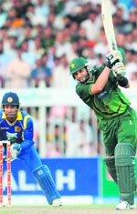 Pakistan's Shahid Afridi (R) bats as Sri Lankas Kumar Sangakkara looks on during the fourth ODI match in Sharjah on Sunday