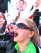 Syrian women join a rally to show their support for President Bashar al-Assad in Damascus.