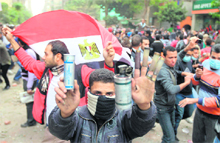 An Egyptian protester shows rubber-bullet shells and teargas canisters during clashes with the riot police at Cairos landmark Tahrir Square on Sunday. 