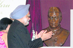 Prime Minister Manmohan Singh gestures after unveiling Jawaharlal Nehru's bust and commemorative marker in Singapore on Sunday. 