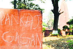Inscriptions defacing the walls and (below) visitors have reduced the martyrs well into a wishing well in the Jallianwala Bagh in Amritsar.