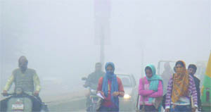 Girls walk in fog in New Delhi on Sunday morning. 