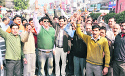 Shopkeepers of the Chakrata road hold a protest at the Clock Tower, Dehradun,