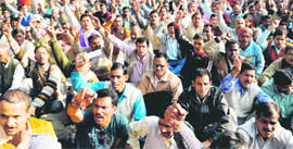 Class IV employees of the state government hold a demonstration in support of their demands in Dehradun on Monday.