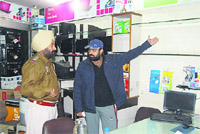 The shop owner points to the empty shelves of his shop. Thieves took away laptops at Central Town in Jalandhar