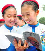 Schoolgirls from South Korea reading the autobiography of Mahatama Gandhi at the Rajghat in New Delhi on Monday. 