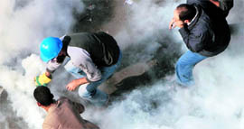 Protesters brave tear gas fired by riot police at Cairos Tahrir Square.