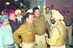 Additional Deputy Commissioner Sat Pal Joshi visits the jewellery shop where the robbery took place