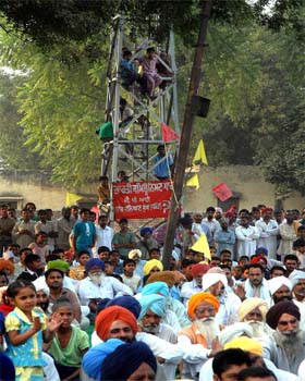 Taking risks, kids climb up a tower to see and listen to PPP chief Manpreet Singh Badal and a noted comedian Bhagwant Mann during a rally at Gobindpura village near Bathinda on Tuesday