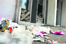 Broken windows and filth strewn at the community centre in Sector 30.