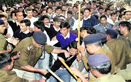 Policemen resort to a lathi charge on BTC trainees during their protest in Dehradun on Tuesday