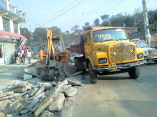 PWD officials remove encroachments in the Ghuggar area of Palampur town. 