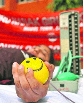 A girl donates blood during a camp at Guru Nanak Girls College in Ludhiana on Tuesday