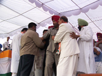 Former minister Pandit Balmukand Sharma trying to secure a place on the stage during the Punjab Bachao Rally of Congress in Ferozepur on Wednesday.