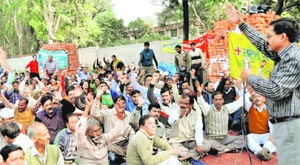 Striking Class IV employees of the government hold a demonstration in Dehradun on Wednesday. 
