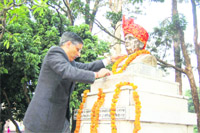 Dr Anil Chauhan, Principal, DRPGMC, Tanda, garlands the statue of Rai Bahadur Jodhamal at the college in Tanda 