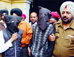 Ritish Sharma and Rinkle Masih in police custody in Amritsar on Thursday