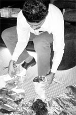 An official takes a sample during a raid at a hookah bar in Sector 8, Panchkula