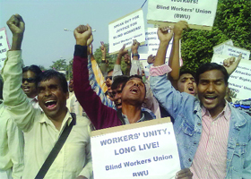 Visually challenged workers, who have been locked out of the production unit run by the National Federation of the Blind, protest against their retrenchment outside the unit in south Delhi on Thursday.