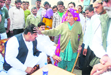 Ajay Singh Chautala seeks blessings of an elderly voter during campaigning in the Adampur constituency on Thursday.