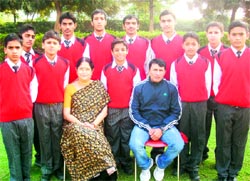 A group photo of swimmers of Gateway International School, Sonepat, with the school principal and swimming coach Ramesh Dabas